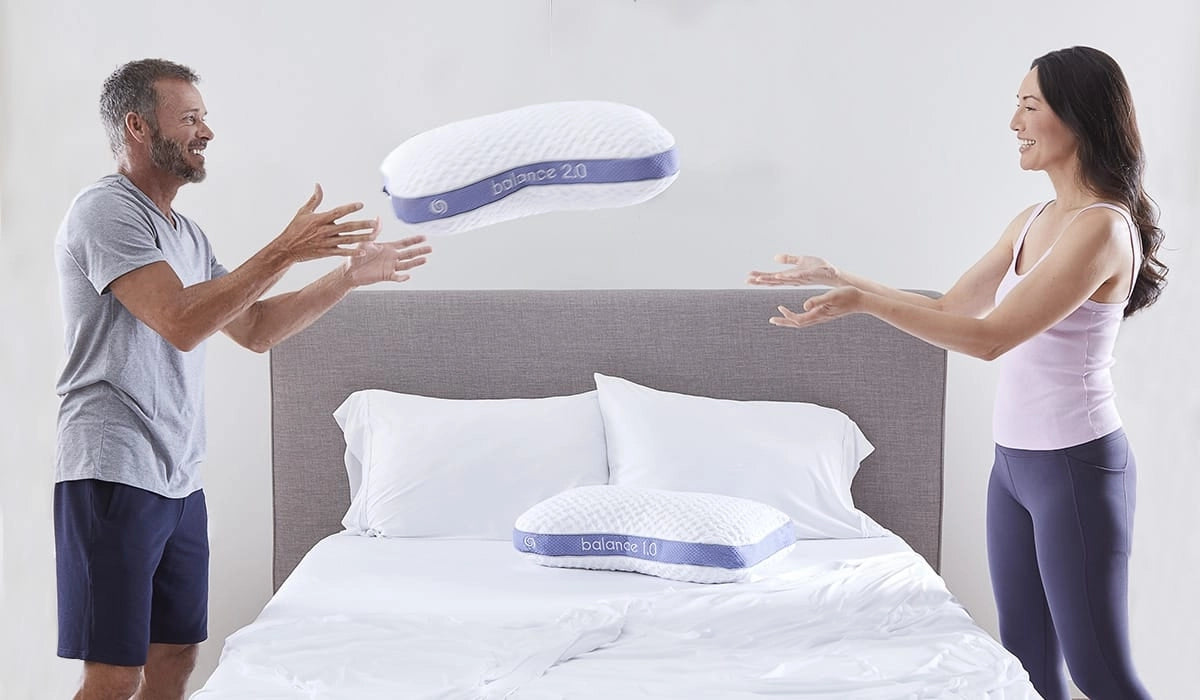 couple throwing balance bedgear pillow 